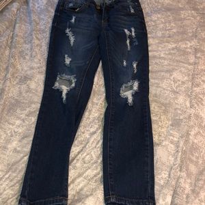 dark blue ripped jeans.